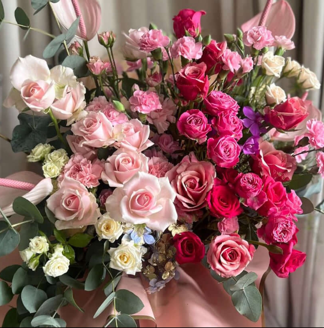 Elegant bouquet of pink and deep red roses with green eucalyptus leaves for love and anniversary.