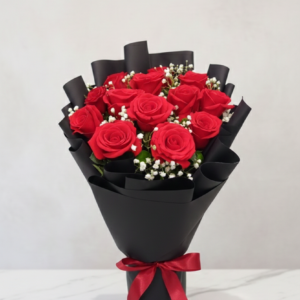 Red roses in black wrapping with red ribbon by Gull Flowers.