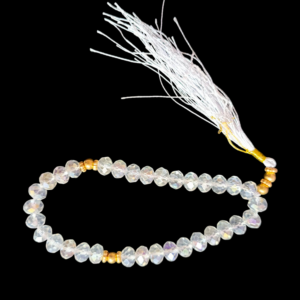 Shining transparent crystal prayer beads (tasbeeh) with golden separators and a long white tassel.