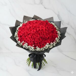 Grand red rose funeral bouquet with white gypso in black wrap by Gull Flowers.