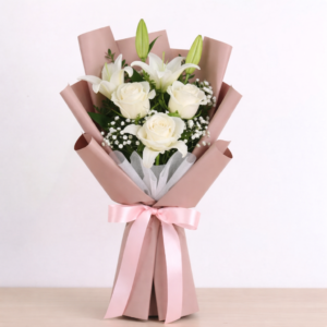 White roses and lilies bouquet in pink wrapping for get well soon by Gull Flowers.